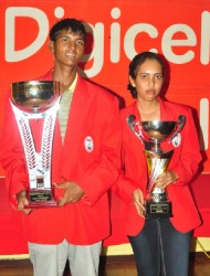 Guyana Open golf winners Avinda Kishore and Christine Sukhram with the trophies. (Orlando Charles photo)