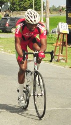 All Alone! National rider, Marlon ‘Fishy’ Williams, raises his hand in victory after powering to his fourth signature win of the season yesterday at the Seawall Bandstand.