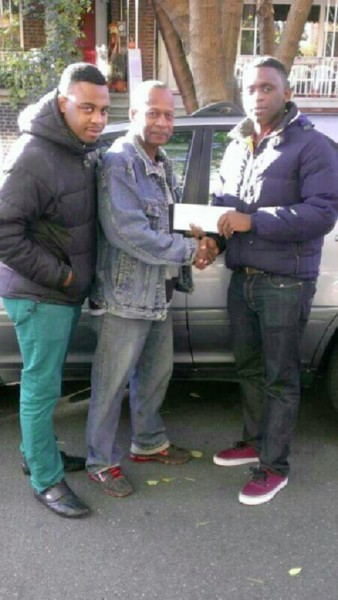 Whiddon Sibdhannie presents the sponsorship cheque to Andrew Major as Sharrief Major looks on.