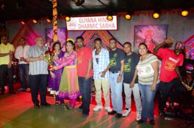 President Donald Ramotar and First Lady Deolatchmee Ramotar present a trophy to members of the Progressive Youth Organisation (PYO) for being judged the overall best Diwali motorcade float. (Government Information Agency photo)