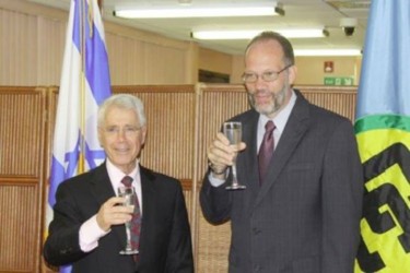 Amiram Magid (left) and Irwin LaRocque sharing a toast (Caricom photo)