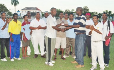 Man-of-the-match Clifton Anderson receiving his MVP award from former national fast bowler Robert `Pacer’ Adonis