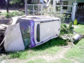 The Toyota Probox lying across the ditch 