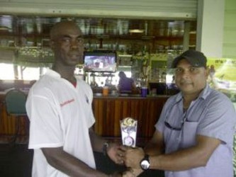 Man of the match Clive Grimmond receiving his award from owner of United Awning’s Ray Persaud