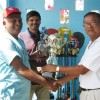  Clifton Phillips (R) hands over the trophies to BVA President Gregory Rambarran in the presence of Rollers Club President, Tony Rambarran.