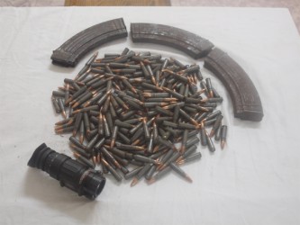 The three AK-47 rifle magazines, rounds of 7.62 x 39 ammunition, and telescopic night vision lens recovered by police after a shootout during a drug eradication exercise at 15 Miles, Ituni Backdam on Thursday afternoon. (Guyana Police Force Photo)