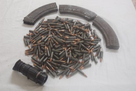 The three AK-47 rifle magazines, rounds of 7.62 x 39 ammunition, and telescopic night vision lens recovered by police after a shootout during a drug eradication exercise at 15 Miles, Ituni Backdam on Thursday afternoon. (Guyana Police Force Photo)