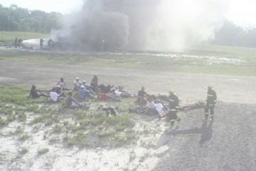 Ranks of the Guyana Fire Service extract ‘passengers’ from crash site to a safe area (GINA photo) 