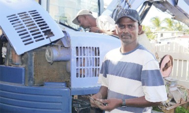 Rajin Armogum taking a break from fixing his excavator