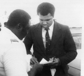 Gordon Alleyne getting an autograph from boxing champion Muhammad Ali.