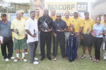 MACORP Invitational Golf tournament winner Jaipaul Suknanan (fifth from right) poses with the other winners and MACORP representatives.