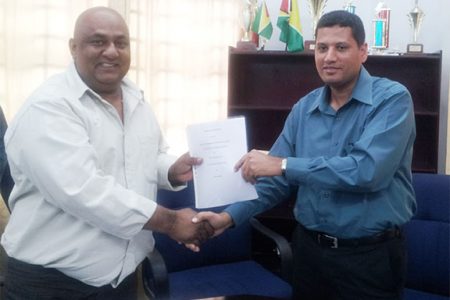 CEO of Natural Globe Inc Mohammed Osman (left) and Ministry of Local Government Permanent Secretary Collin Croal display the MOU.
