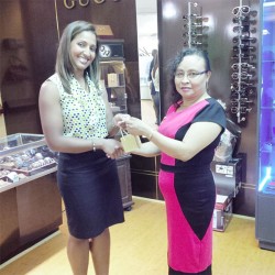 Myra Pierre-Moore (right) receiving her first prize of a diamond necklace, which she won in the United Women for Special Children (UWSC) fund-raising raffle, from a representative of King’s Jewellery, which donated the prize. 