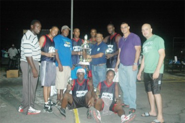 The inaugural winners of the Georgetown Amateur Basketball Association (GABA)-sanctioned Yolo Entertainment Super Sevens title the Pepsi Sonics, posing with their title while members of the GABA and Yolo Entertainment look on. 