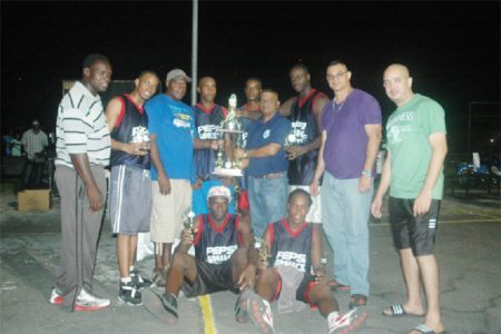 The inaugural winners of the Georgetown Amateur Basketball Association (GABA)-sanctioned Yolo Entertainment Super Sevens title the Pepsi Sonics, posing with their title while members of the GABA and Yolo Entertainment look on.