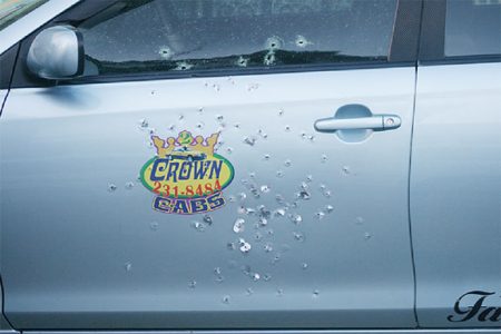 A bullet-riddled Crown Cabs taxi