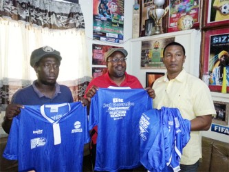 Displaying the donated uniforms from left to right are- Alpha United and National Head Coach Wayne Dover, Caledonia AIA Head Coach Jamal Shabazz and Kashif and Shanghai Co-Director Kashif Muhammad. 