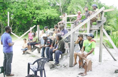 Sharma Solomon (left) speaking to Moblissa residents 