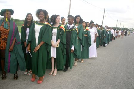 A section of the procession of graduands prior to the 2013 University of Guyana Convocation ceremony yesterday at the Turkeyen Campus, Georgetown. (Photo by Arian Browne)
