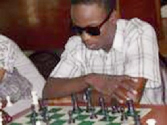 Meusa is back! Wendell Meusa, a former national chess champion emerged last Sunday following a three year hiatus to compete for a place in the 2013 national senior chess championship. Meusa has a certified FIDE chess rating of 1966, and is generally regarded as the highest ranked chess player in Guyana. Usually, he is accompanied by his adoring Mom, sisters, perhaps nieces and nephews, who come to watch him play. The current preliminary tournament will identify seven persons to face Taffin Khan for the national chess championship title. However, it was disappointing to note that Loris Nathoo did not turn up for the tournament on Sunday, as he is one of the strongest chess players around. In the movie A Bronx Tale starring Robert De Niro, a mob boss bar owner asks an unruly group of bikers to leave his bar. They refuse, and the mob boss does a strange thing. He locks the doors and says, now you can’t leave. In the same breath I say to Nathoo, now you can’t play!