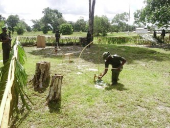 Officer Cadet Lawrence King demonstrating the use of traps in jungle survival