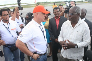 President of CONVIASA Luis Gustavo Graterol Caraballo (left) speaks with Minister of Works Robeson Benn shortly following the arrival of the first CONVIASA flight to Guyana. Looking on is CEO of the Cheddi Jagan International Airport Corporation Ramesh Ghir. 