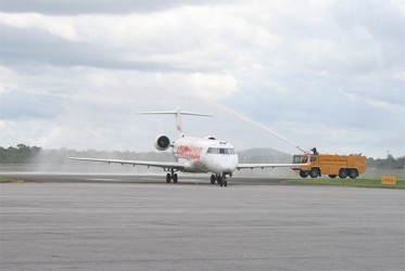 A Fire truck sprays water in a celebratory fashion on the arriving CONVIASA aircraft. 