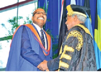 House Speaker Wade Mark, left, is congratulated by University of the West Indies (UWI ) Chancellor George Alleyne after he received his Executive Master of Business Administration (EMBA) degree on October 26, at the graduation ceremony at UWI Spec, St Augustine.