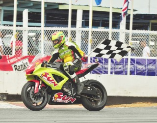 Stephen Vieira flies the checkered flag after claiming victory in the Super Bike segment of the races