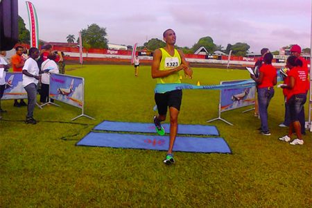 Lionel D’Andrade crossing the finishing line to clinch the top spot in the men’s open division of the Suriname Marathon
