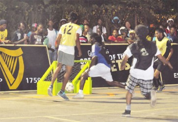 South Sophia’s Ryan O’Selmo (No. 12) having his initial right-footed strike denied by the left upright against Norton Street-East (black vests) in their Group H matchup