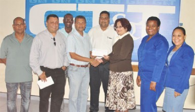 GCB Secretary Anand Sanasie (fourth from left) receives the sponsorship cheque from GT&T Director of Sales, Marketing and Public Relations Roma Narayan-Singh, while other representatives of the GCB and GT&T look on.  