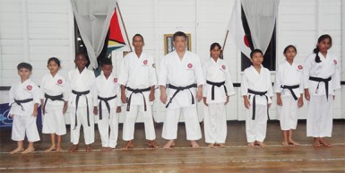  Shuseki Shihan Frank Woon-a-Tai (fifth from right)  is flanked by, from left, Rajiv Lee, Rachael Ramlal, Khalid Adams, Tyler Orderson (2nd Dan)  and Sensei Jeffrey Wong and from right, Mickelly Rahaman, Rabecca Ramlal, Zane Low and Alyssa Persaud (2nd Dan). 