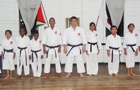  Shuseki Shihan Frank Woon-a-Tai (fifth from right)  is flanked by, from left, Rajiv Lee, Rachael Ramlal, Khalid Adams, Tyler Orderson (2nd Dan)  and Sensei Jeffrey Wong and from right, Mickelly Rahaman, Rabecca Ramlal, Zane Low and Alyssa Persaud (2nd Dan).
