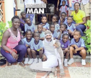 Michael Taitt with children at one of his performances (Barbados Nation photo) 
