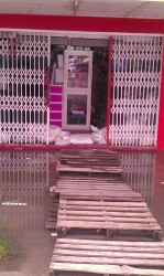 Some businesses erected mounds of sand bags to battle the floodwaters yesterday in Regent Street.  