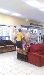 Employees at Courts fetching new stock into the store after appliances and furniture on the ground floor was damaged by flood waters on Wednesday.  