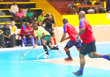 Hikers striker Aroydy Branford (left) on the attack against YMCA of Barbados