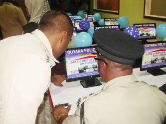 Police Commissioner Leroy Brumell on one of the computers donated to the training facility.  