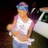 Danielle Davis comforting the crying baby boy who was found in a travelling bag in Bonham Spring, St Ann, Wednesday night.