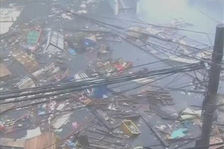 Debris float on a flooded road as strong winds and rain continue to batter buildings after Typhoon Haiyan hit Tacloban city, Leyte province in this still image from video November 8, 2013.
REUTERS/ABS-CBN via Reuters TV