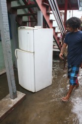An Albouystown resident showing SN his damaged fridge.