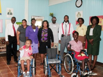 In photo are two of the recipients of the wheelchairs with officials of the hospital.