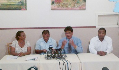 Charrandass Persaud (second from right) sits among his colleagues on Friday 