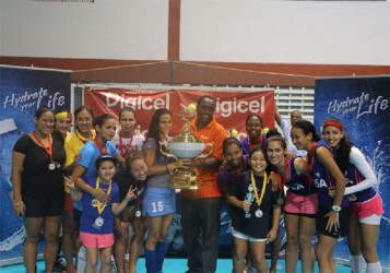 Women’s champions GCC Tigers posing with their championship trophy with Digicel Event Manger Gavin Hope (centre) following their victory over Malvern of Trinidad and Tobago 