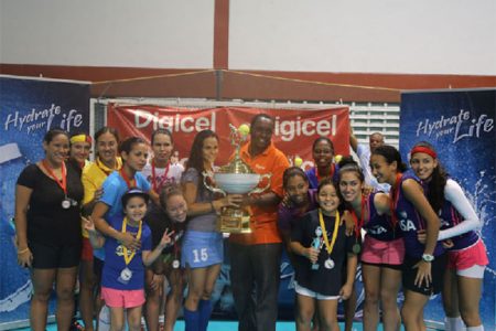 Women’s champions GCC Tigers posing with their championship trophy with Digicel Event Manger Gavin Hope (centre) following their victory over Malvern of Trinidad and Tobago
