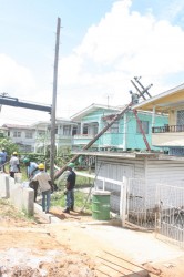 GPL workers trying to remove the fallen pole. (Photo by Arian Browne) 