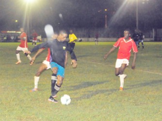 Mahaica Determinators Azuma Roberts (in black) trying to keep possession against Riddim Squad defender Linden Pickets (behind) during their sides’ bruising matchup 