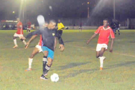 Mahaica Determinators Azuma Roberts (in black) trying to keep possession against Riddim Squad defender Linden Pickets (behind) during their sides’ bruising matchup
