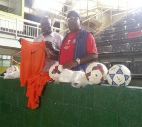 Former head coach of the Golden Jaguars, Jamal Shabazz (right) presenting a quantity of bibs and game balls to co-founder of the Kashif and Shanghai (K&S) Organization, Aubrey ‘Shanghai’ Major yesterday in Trinidad. 